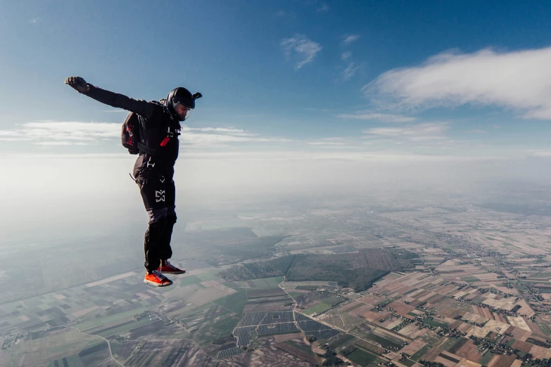 the skydiver is in mid air and is about to land