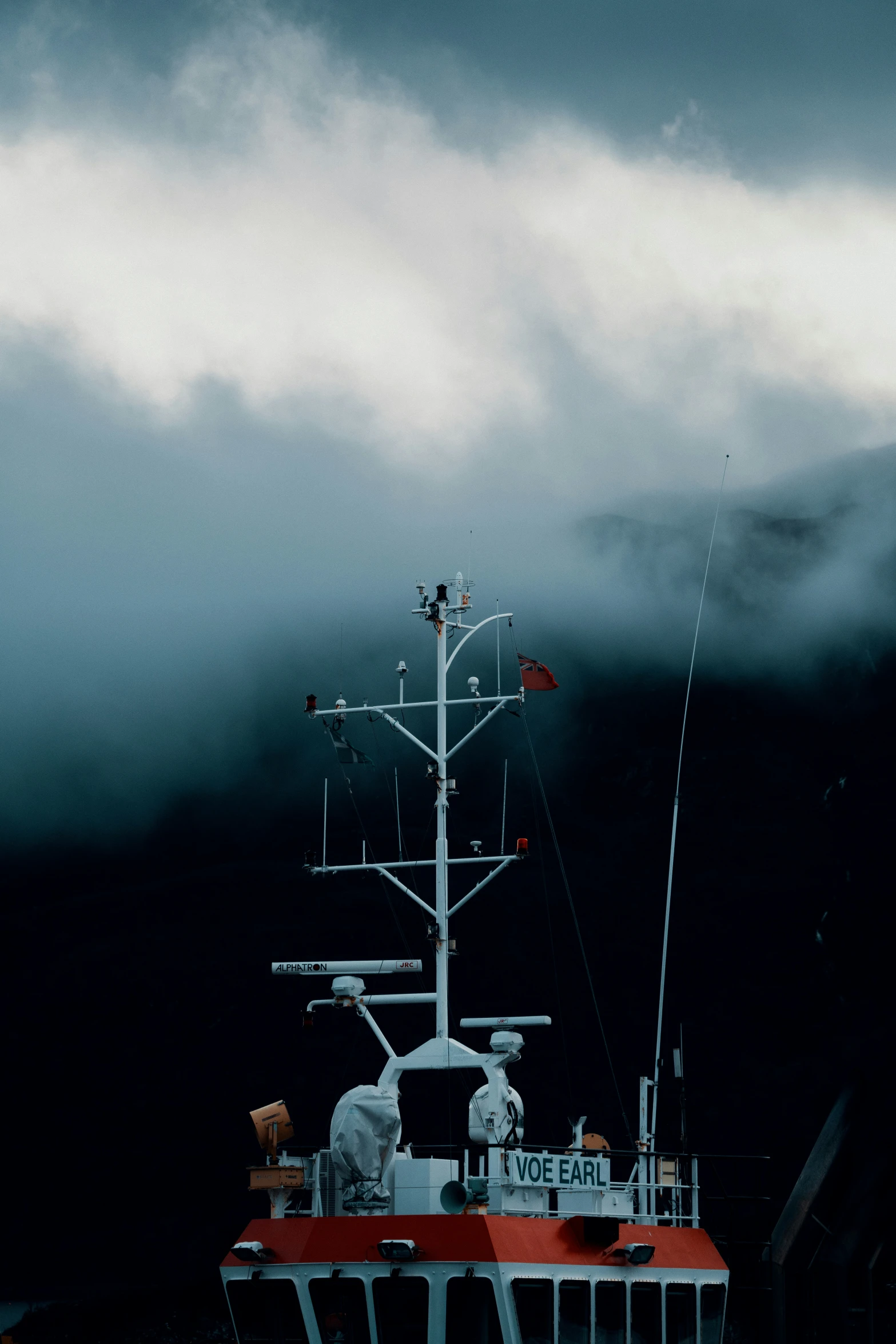 the boat is surrounded by clouds while it is on the water