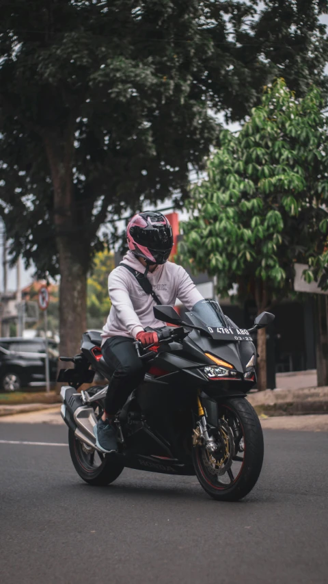 the motorcyclist has been stopping at the traffic light