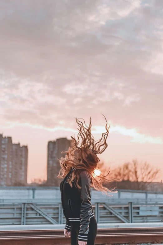 a young woman with her hair blowing in the wind