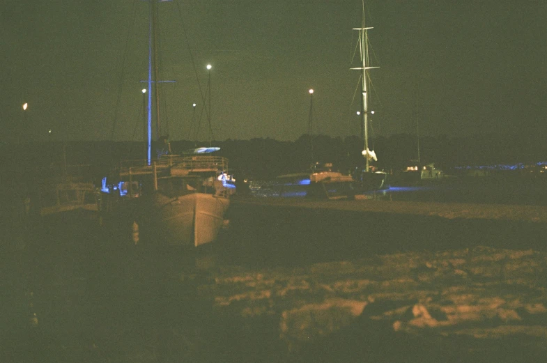 a blurry po of a harbor with a boat out at night