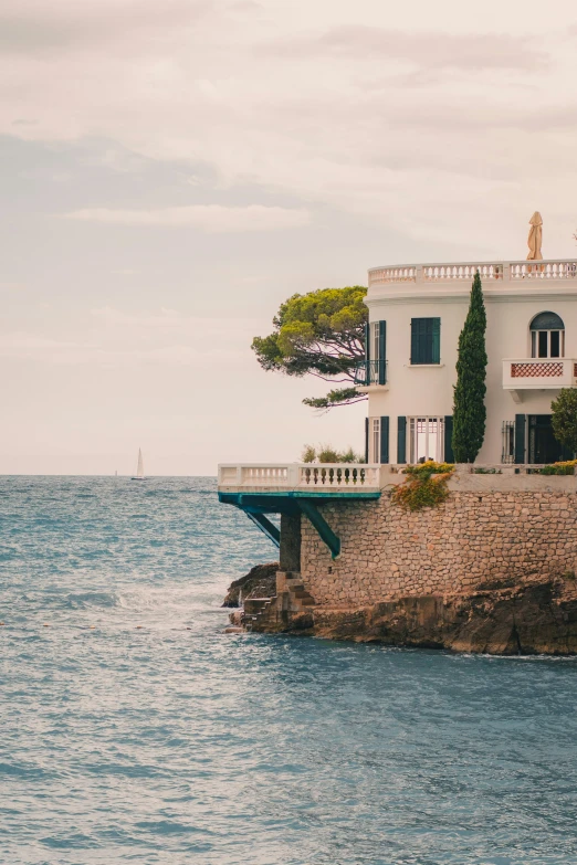 there is a building on top of a cliff next to the water