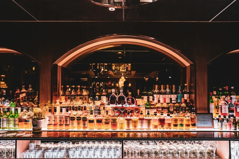 an array of liquor glasses in front of a display