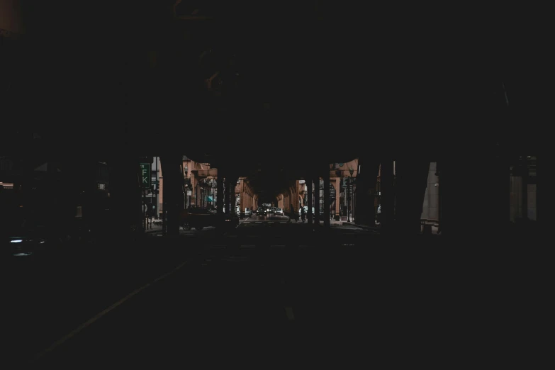 nighttime po of a dark city street with buildings