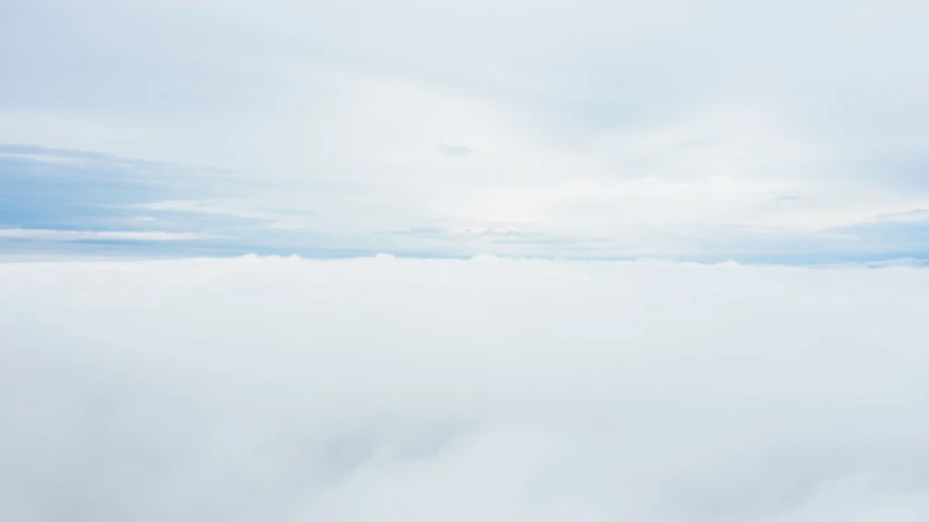 a sky with white clouds in it and one is flying above