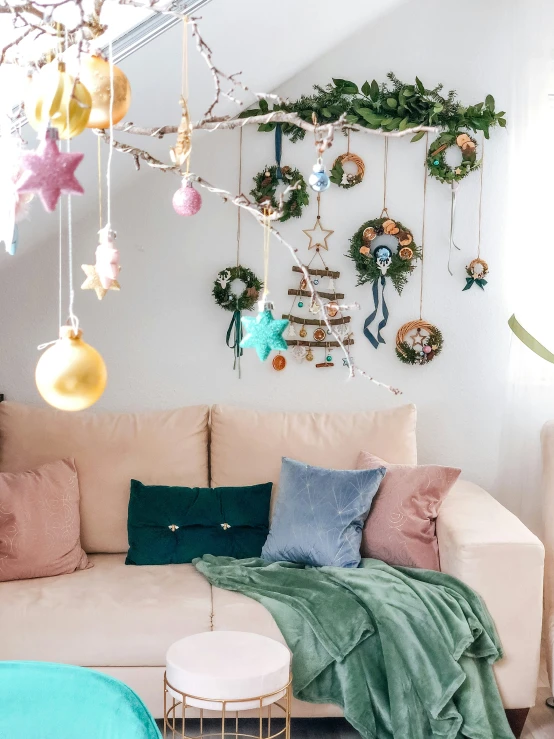 a living room with christmas decorations hanging above it