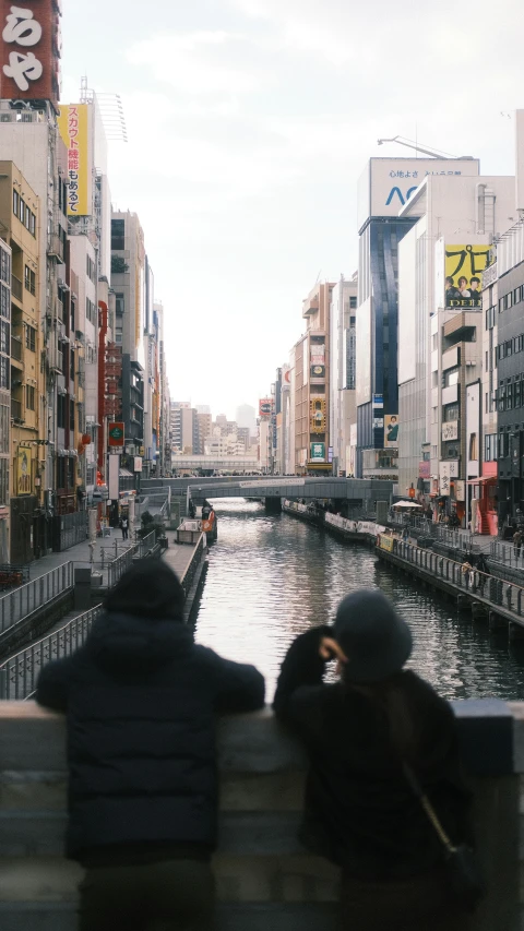 two people sitting on the side of a boat