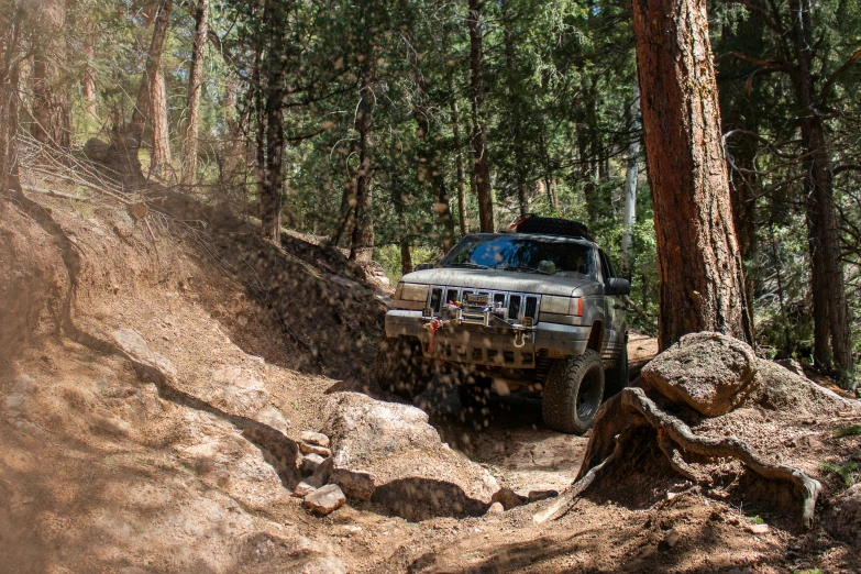 the jeep is driving through a muddy obstacle course