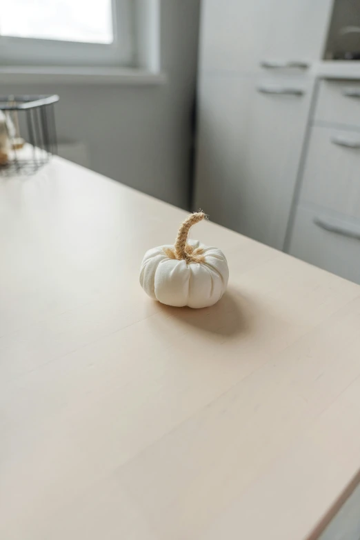 a pumpkin sitting on top of a wooden table