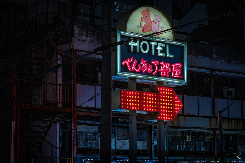 a lighted motel sign at night on a pole