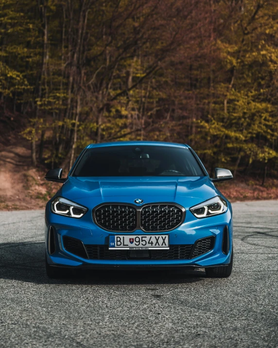 a blue sports car sits parked in the parking lot