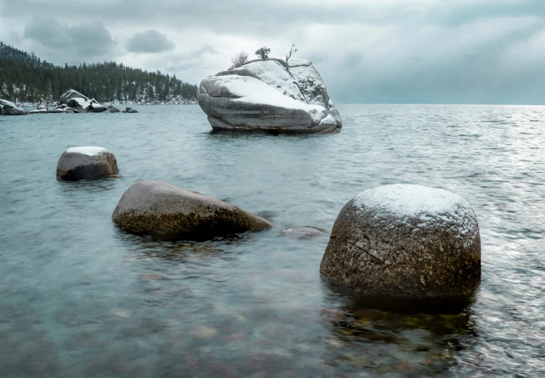 a rock covered beach near some water