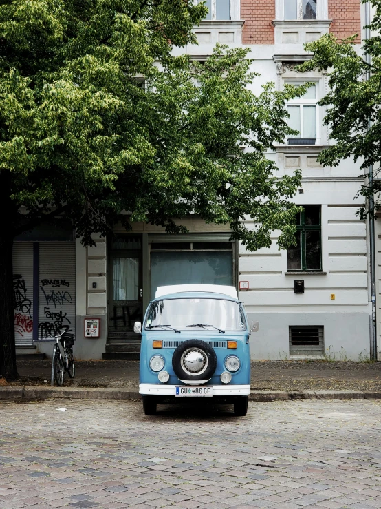 an old van sits parked on a street