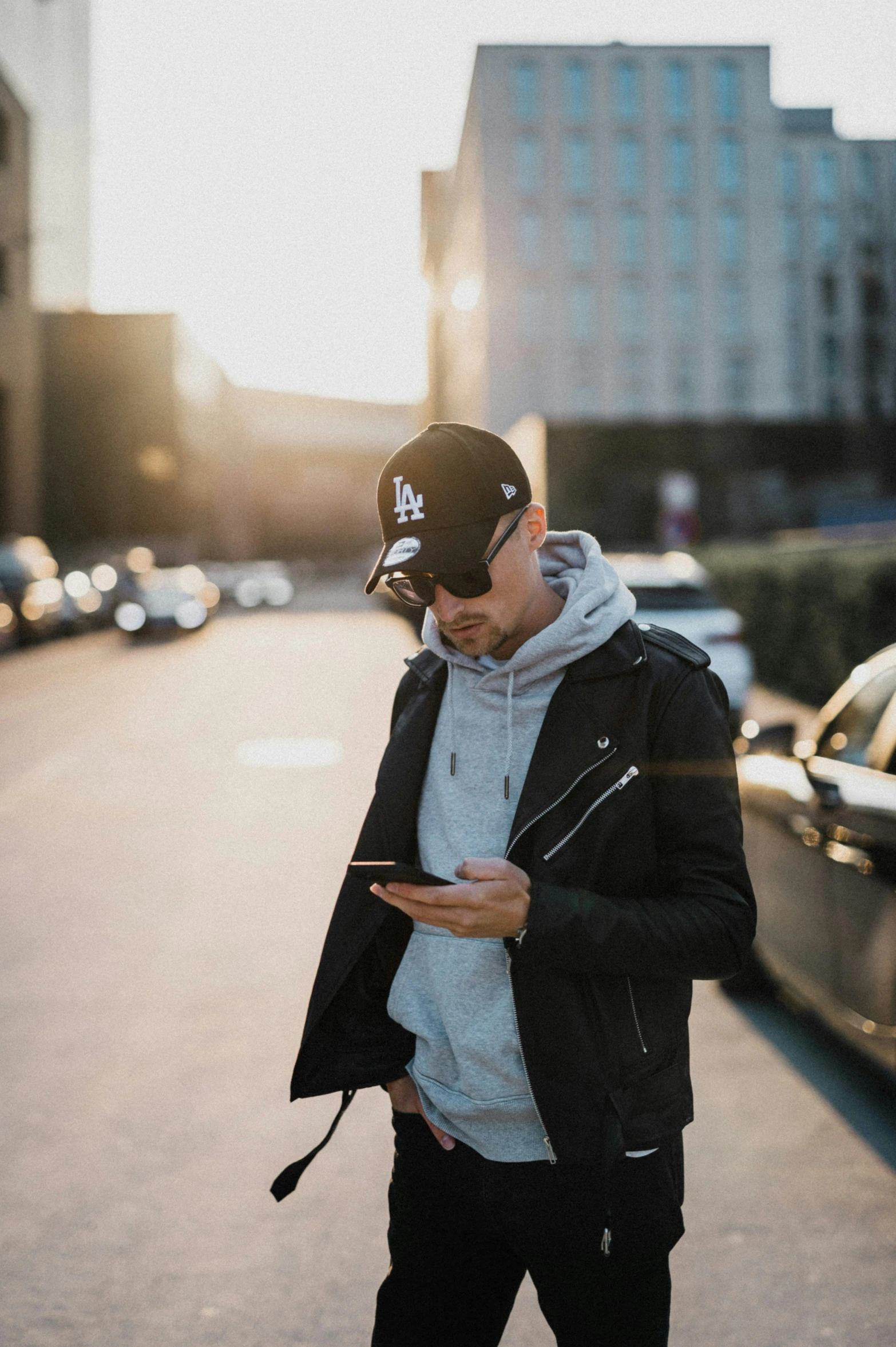 a person on a city street, looking at his phone