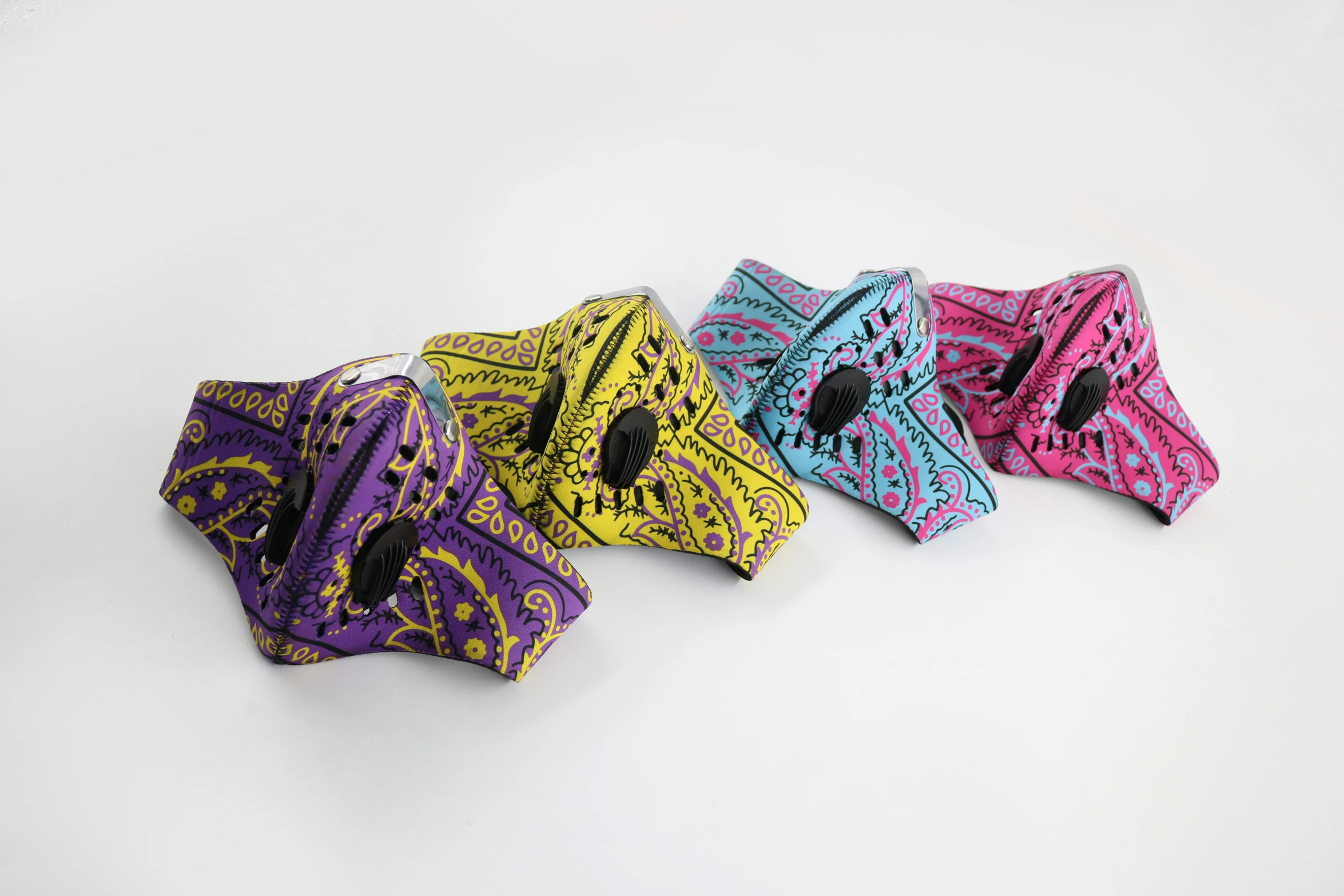 four different color patterned bags sitting on top of a table