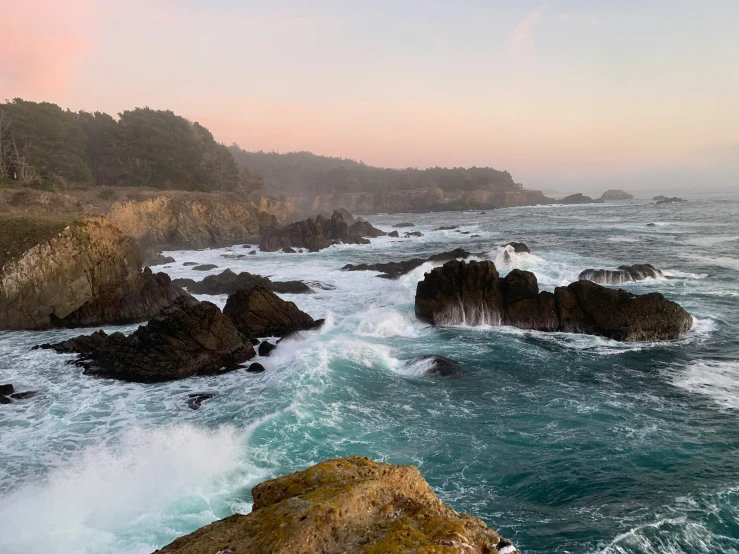 water splashes down rocks on a rocky coast