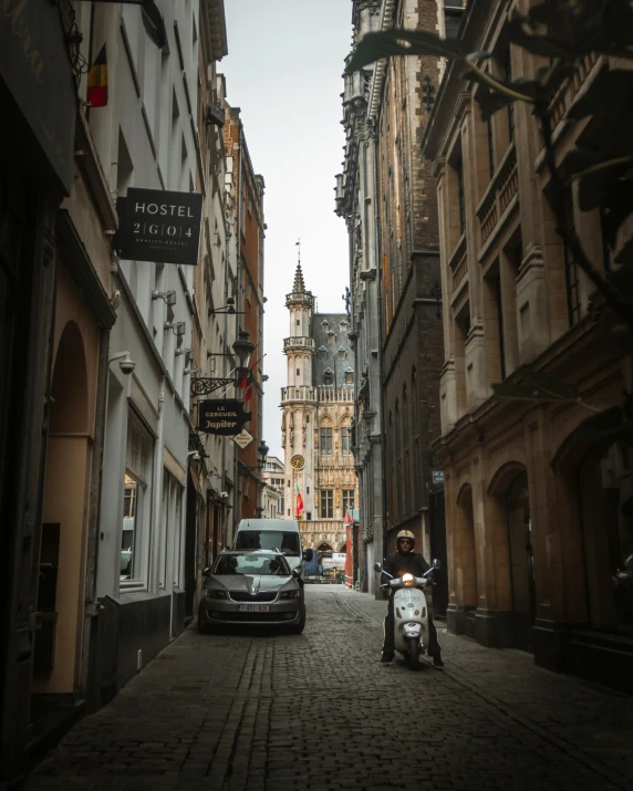 there is a motorcycle parked along this old city street