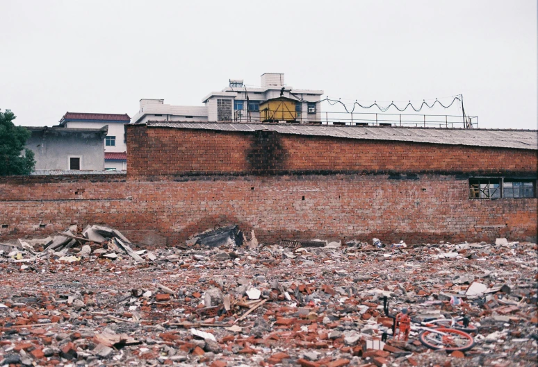 a view of a building, roof and buildings on a hill