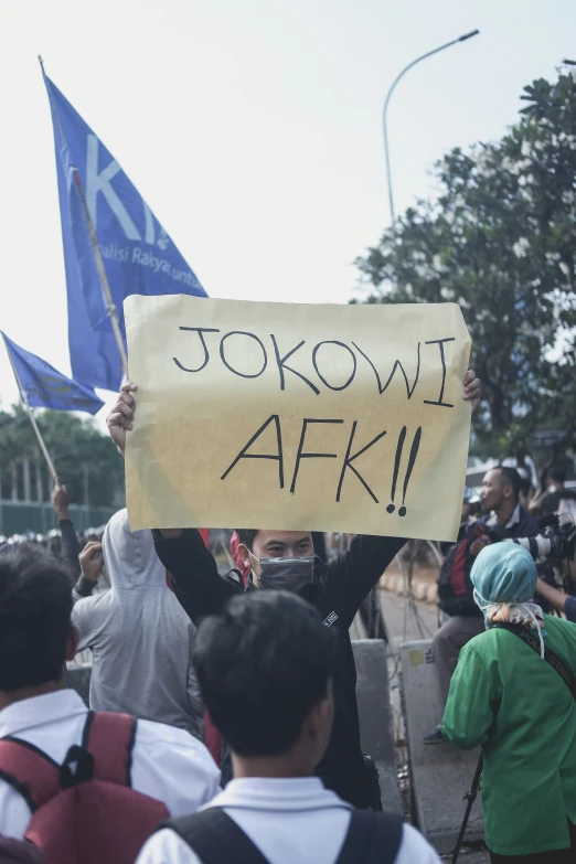 people are holding protest signs with asian writing on them