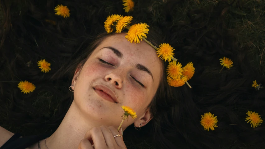 there is a woman laying in flowers that are around her