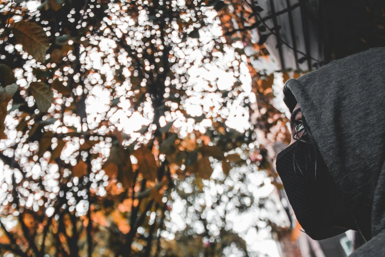 a person in black hoodie using his cell phone