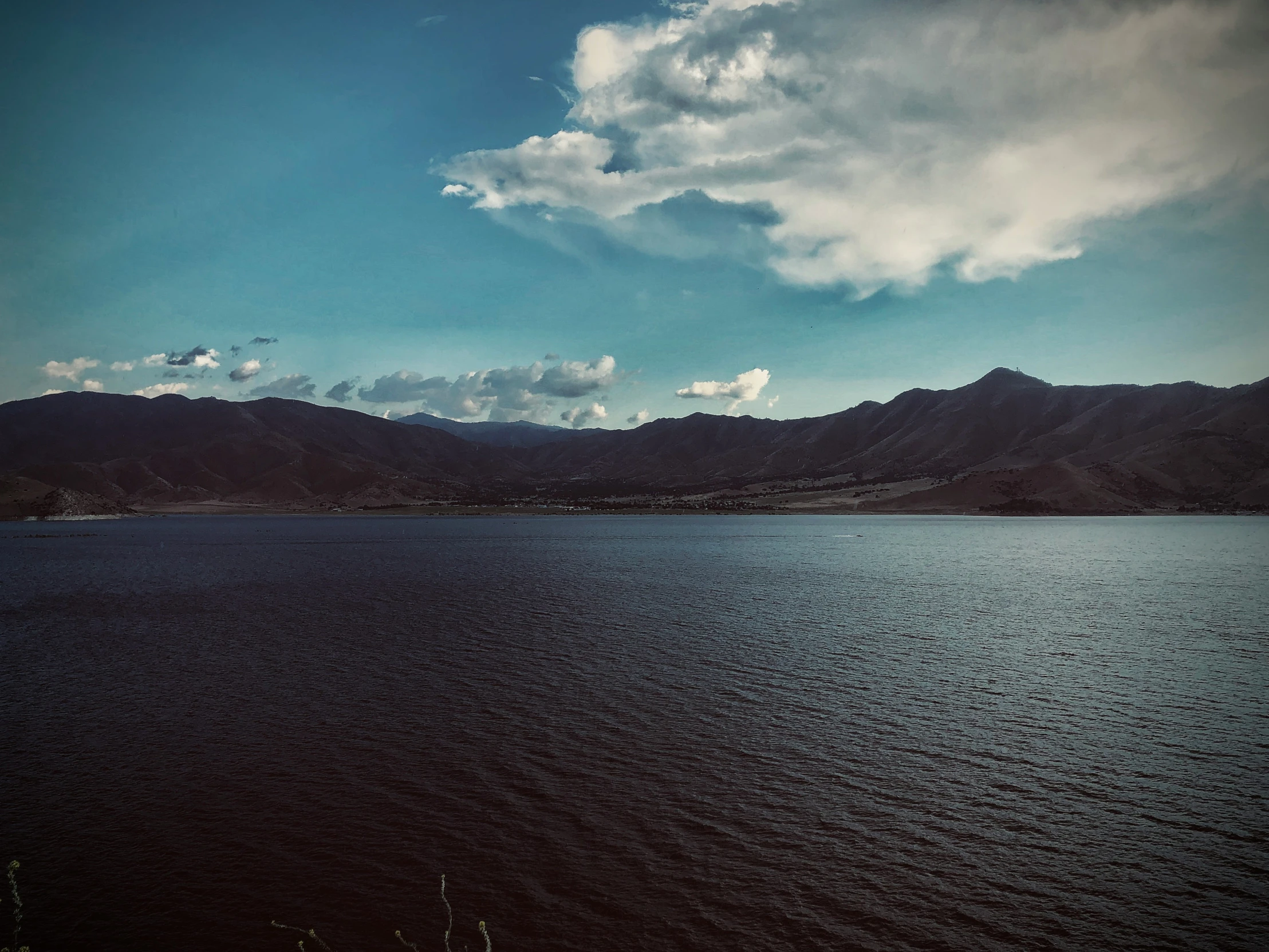 the water is clean and very shiny under a cloudy sky