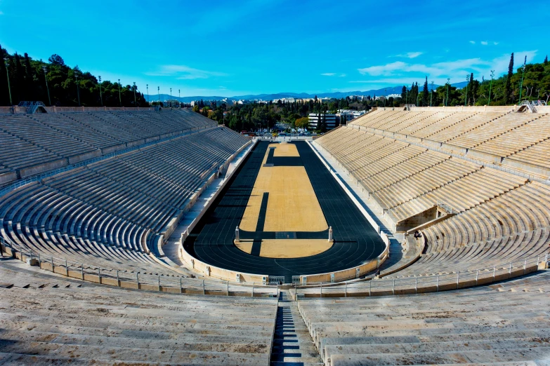 an empty, stone - covered amphit with a yellow tarmac