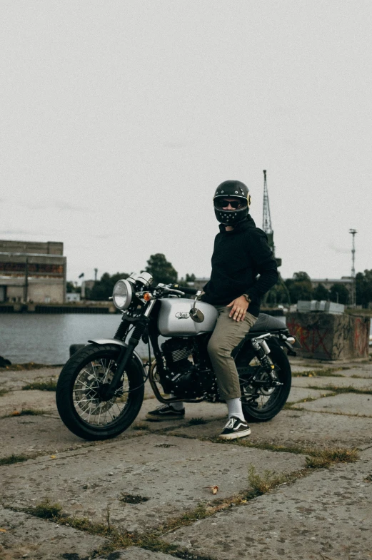 person in black jacket and helmet sitting on motorcycle