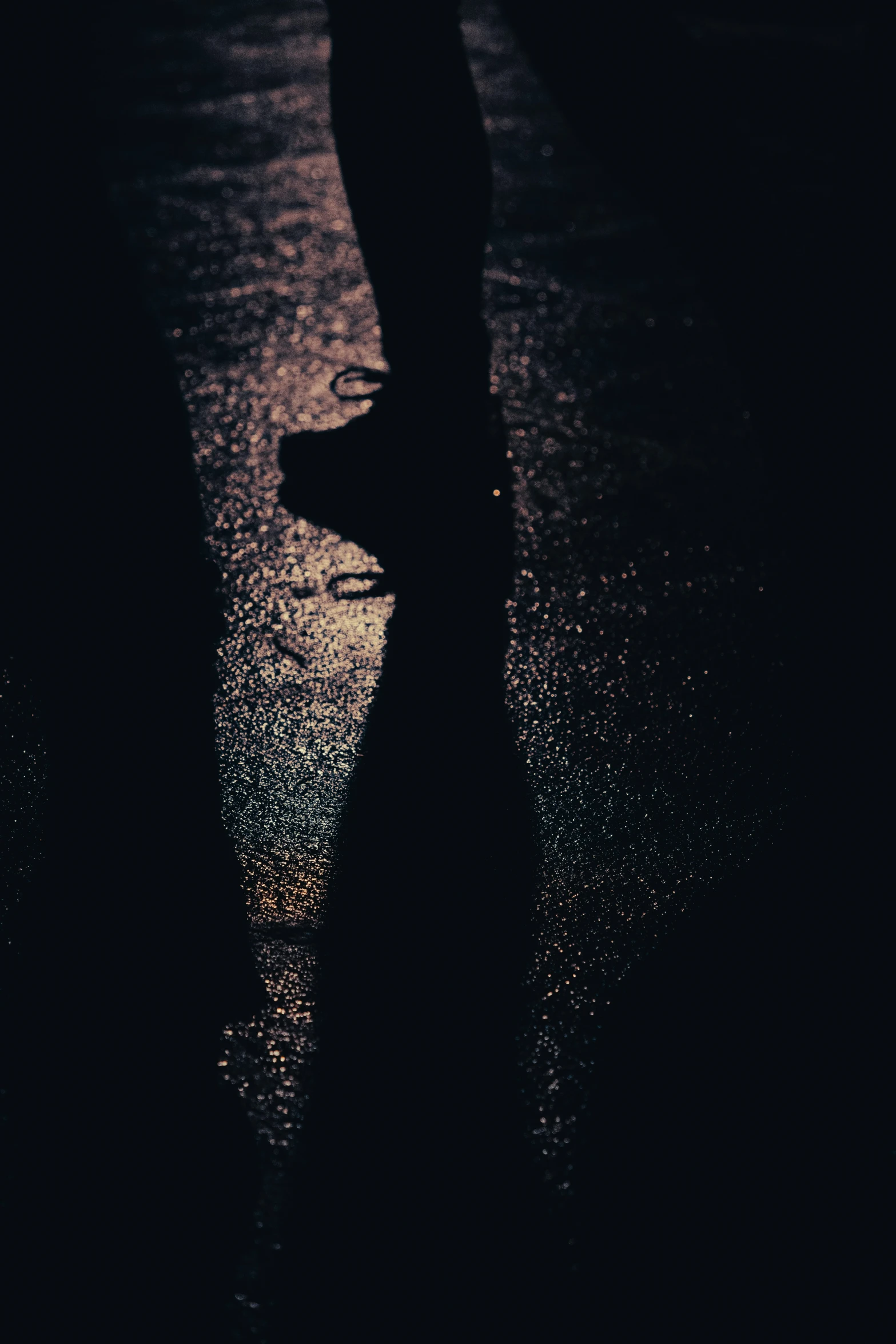 a person standing in the dark with water on the floor