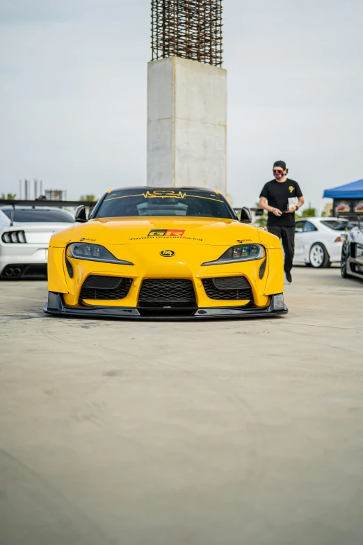 a man is standing next to some cars