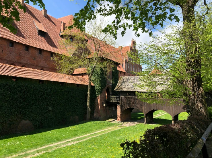 a large building surrounded by green grass and trees