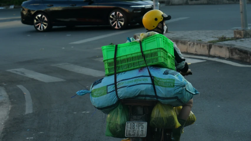 a person riding a motorcycle in front of a car