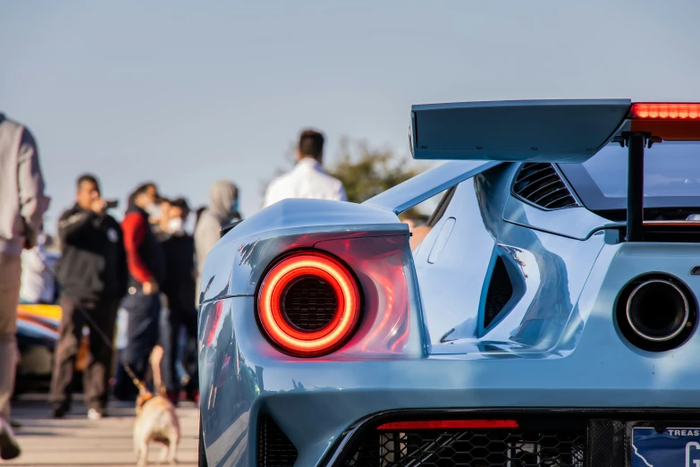 an interesting looking blue car on the road