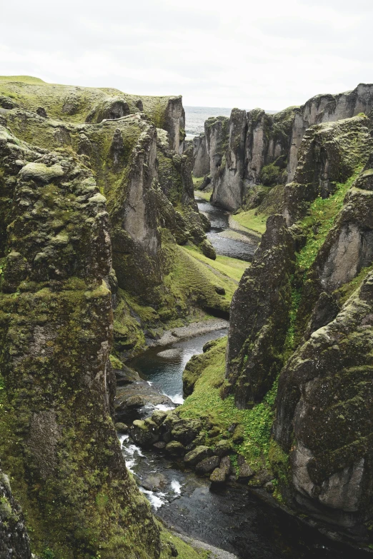 the water is flowing under a rocky area