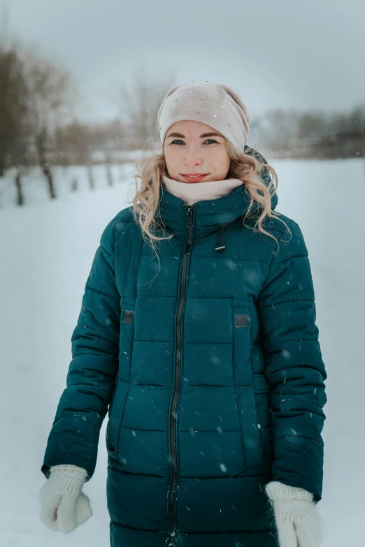 the woman is bundled up in the snow