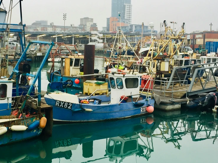 a boat sitting in the water next to other boats