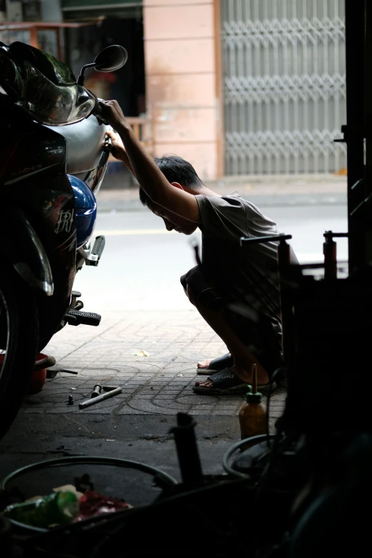 a person touching the handle on a motorbike
