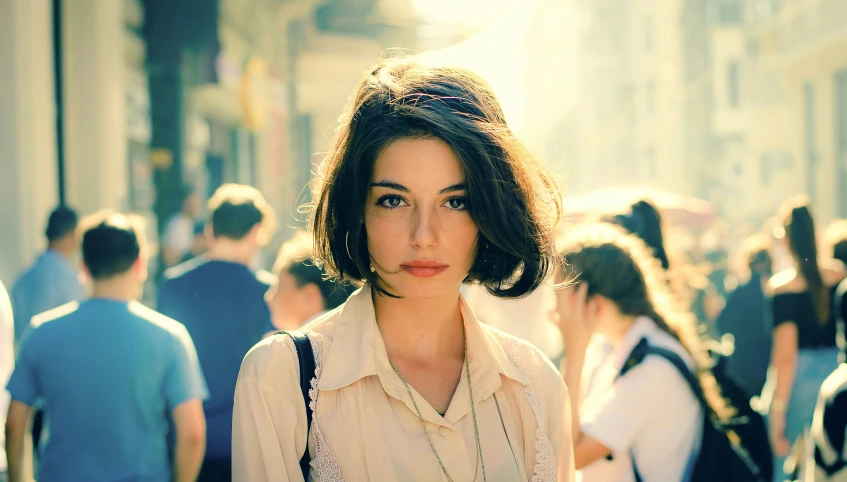 a woman standing in front of many people on the street