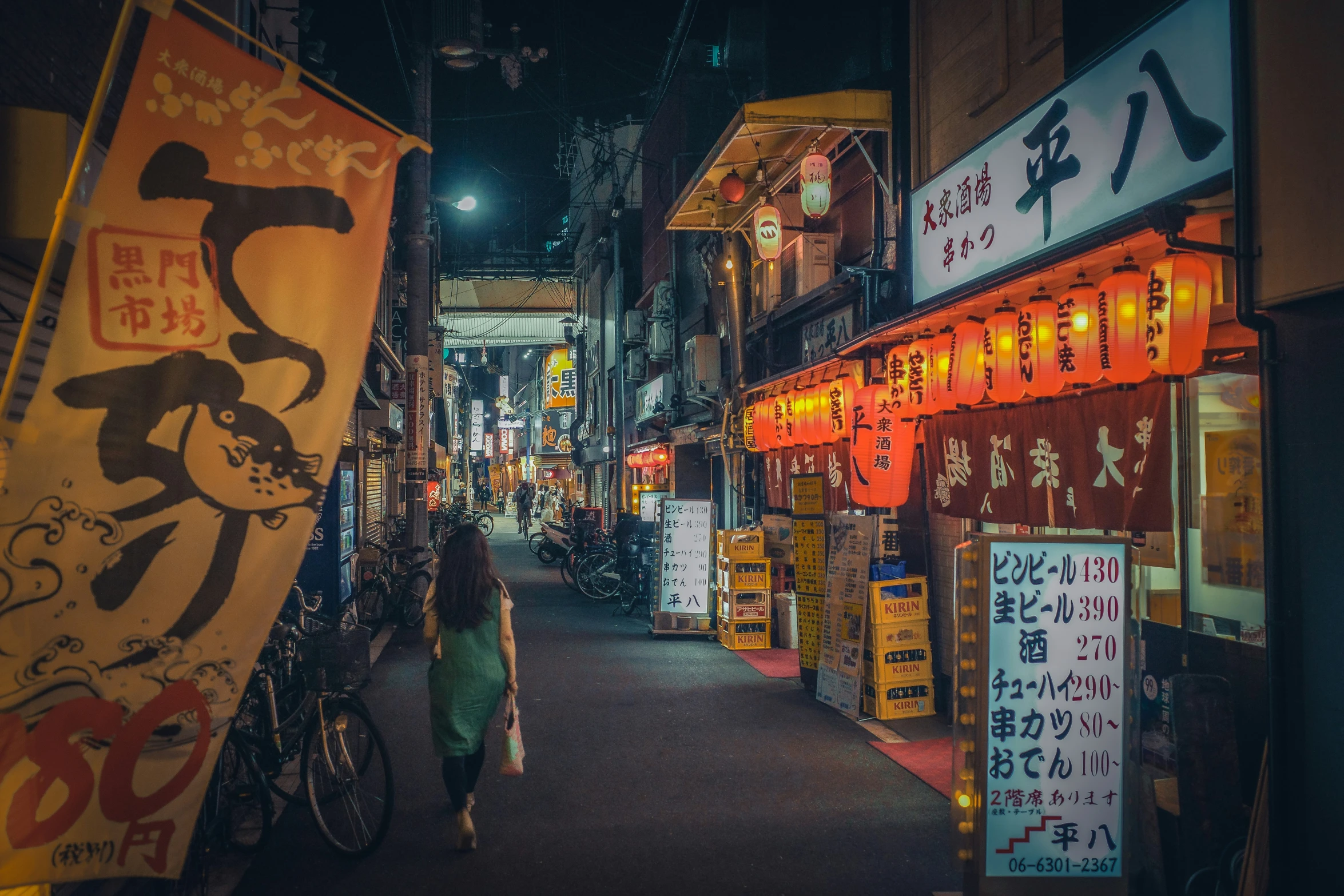 an alley with posters, signs, and other stuff on display