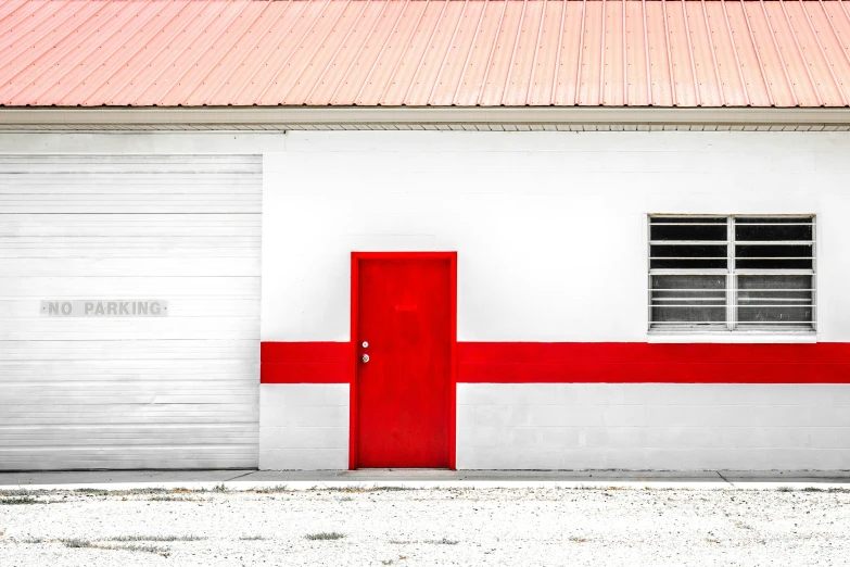 an exterior po of an adobe - style building with red and white stripes