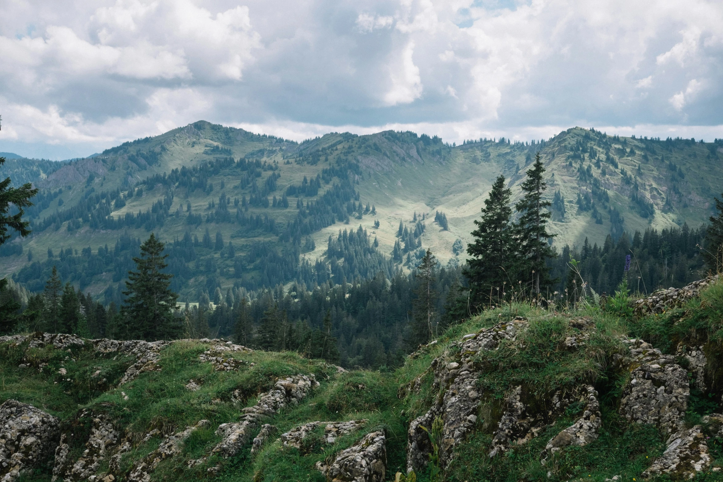 the view from the top of the mountain in the mountains