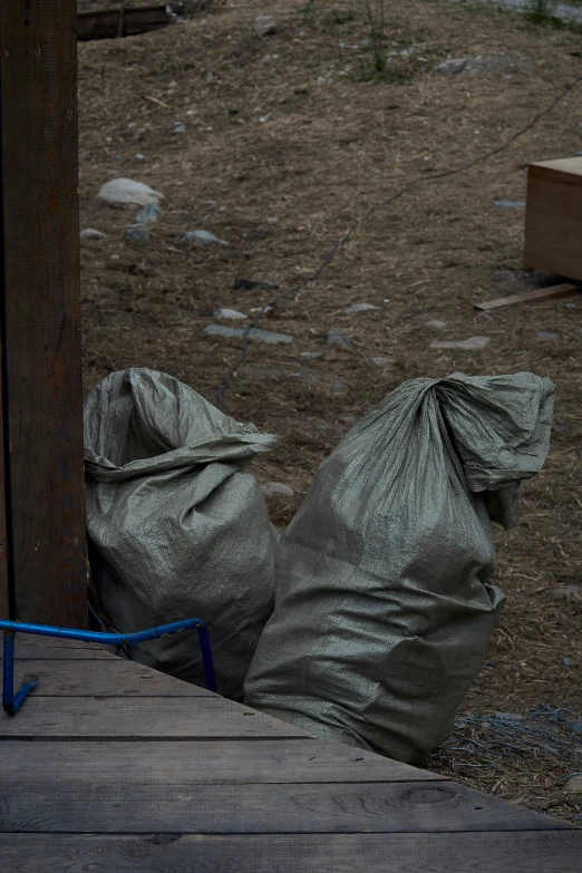 a bag that is on the ground next to a fence