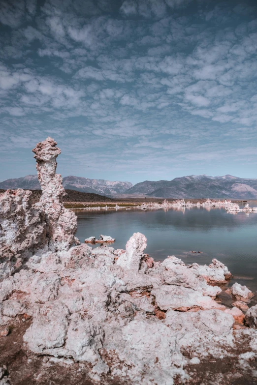 an outdoor park with a bunch of rocks by a lake