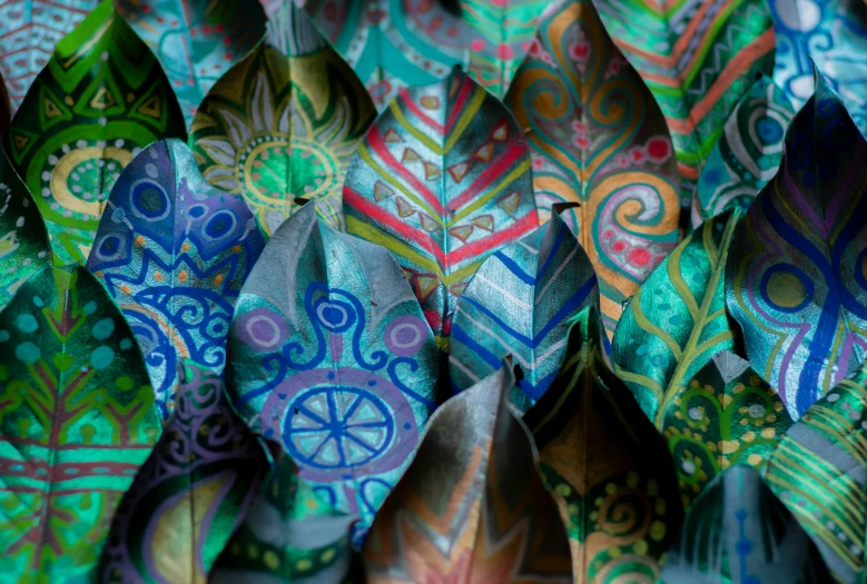 different colorful origami leaves with designs