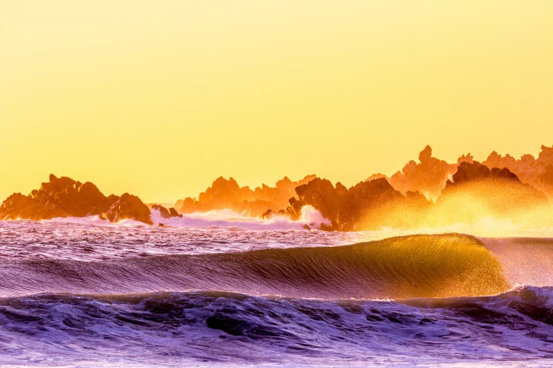 a group of men riding waves at sunset