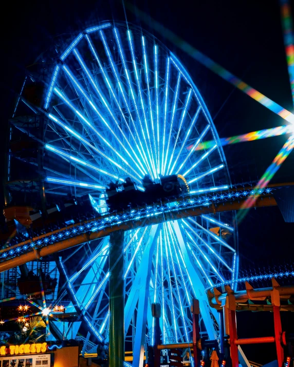 an amut wheel in front of a building lit up with light blue