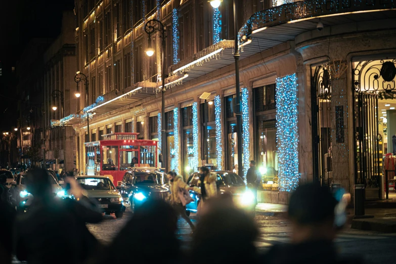 a city street is covered with lights at night