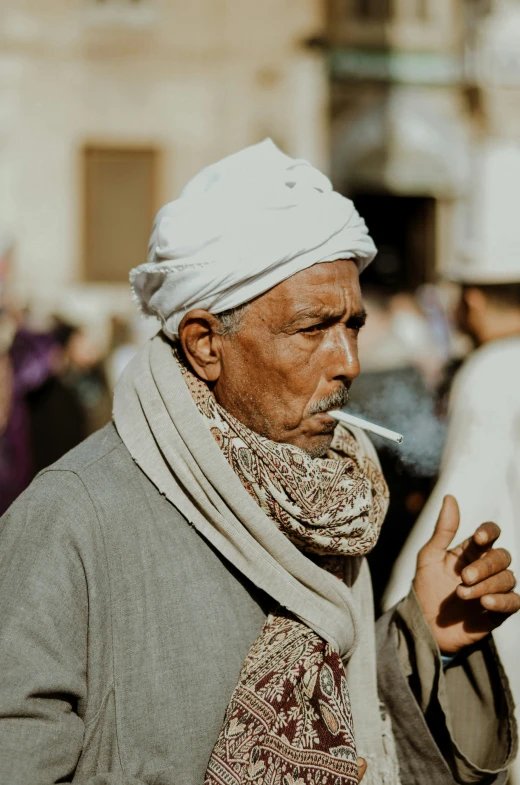 an indian man with a turban smoking a cigarette