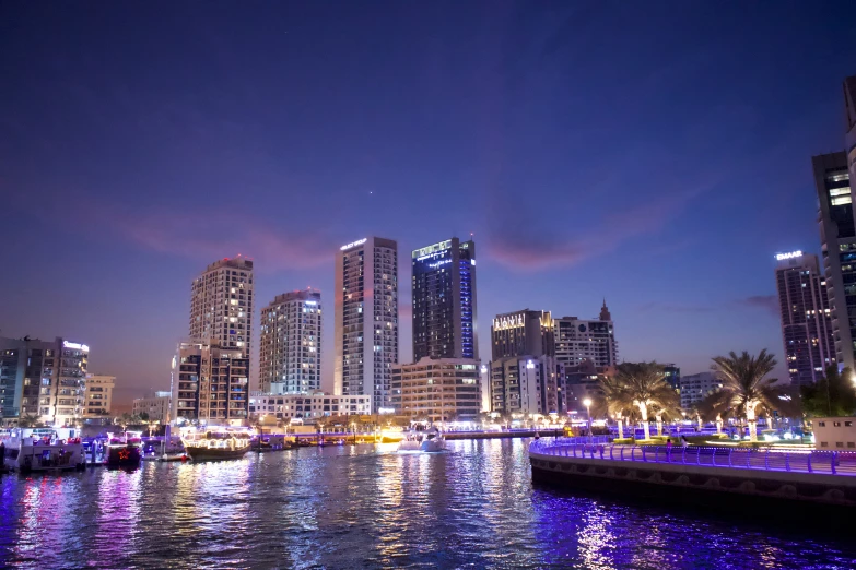 the marina and city lights shine brightly on the night