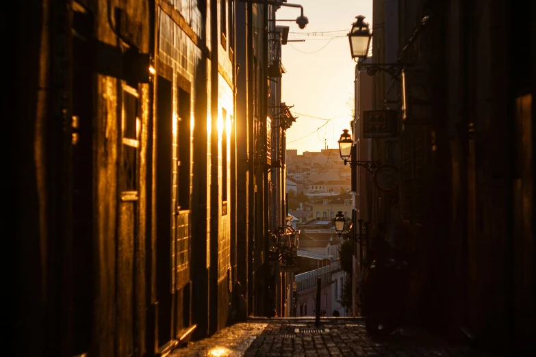 the sun is setting in an alley way